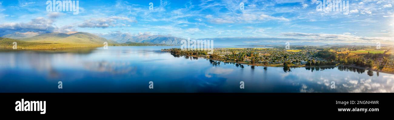 Calm morning over Te Anau lake and town in Fiordland of New Zealand - gateway to Milford Sound. Stock Photo