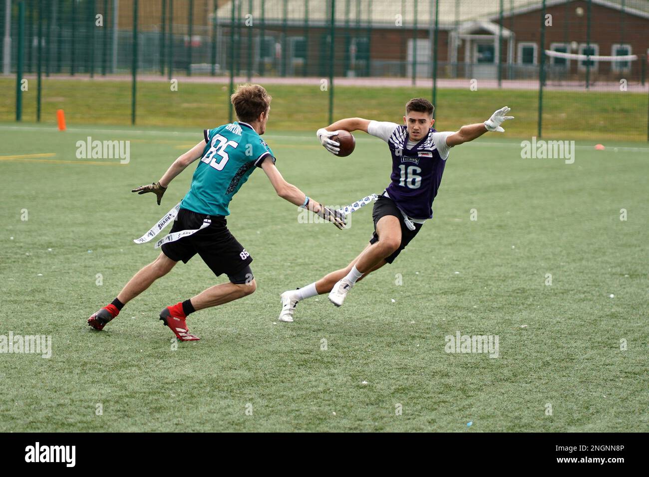 Players running with the ball during a Flag Football game in Wales. Stock Photo