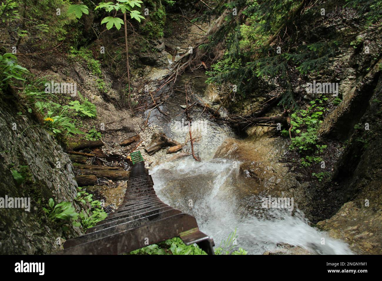 Dangerous trail through a waterfall with steel ladders in the Slovak