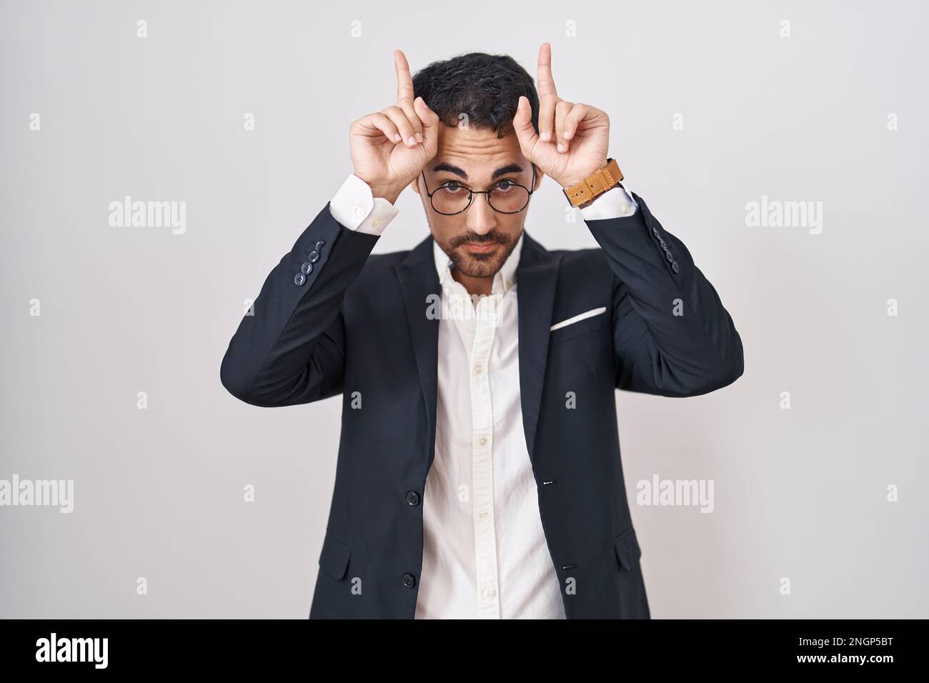 Handsome business hispanic man standing over white background doing ...