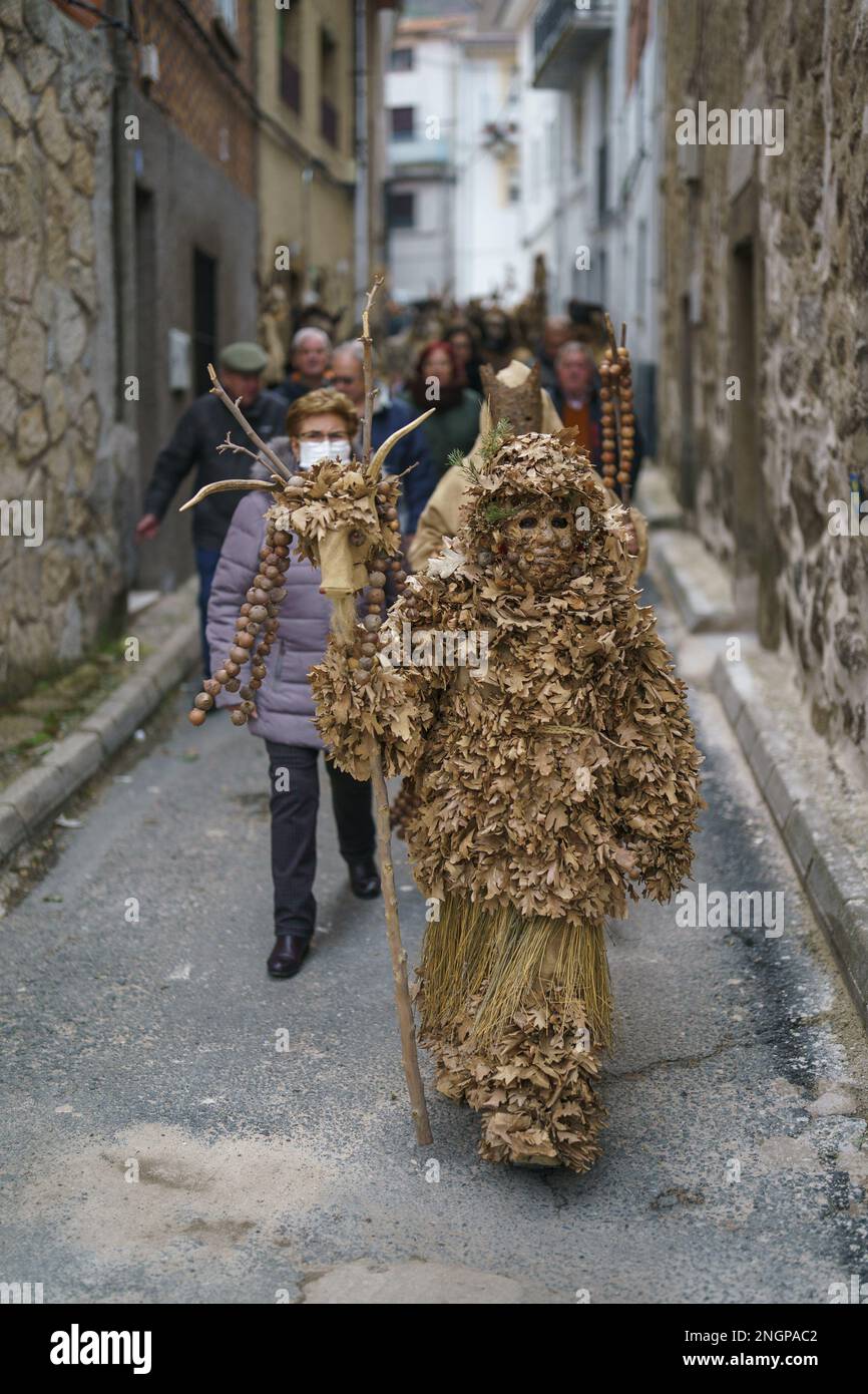 Navalacruz, Spain. 18th Feb, 2023. A carnival reveller dressed as a traditional 'Harramacho' wearing leaves and other agricultural decor takes part in a carnival festival in the village of Navalacruz, Spain, on Saturday, February 18, 2023. The 'Herramacho' figures, whose costumes are made from natural materials collected from the surrounding environment, were believed to protect family and cattle in pre-Roman rituals. Photo by Paul Hanna/UPI Credit: UPI/Alamy Live News Stock Photo