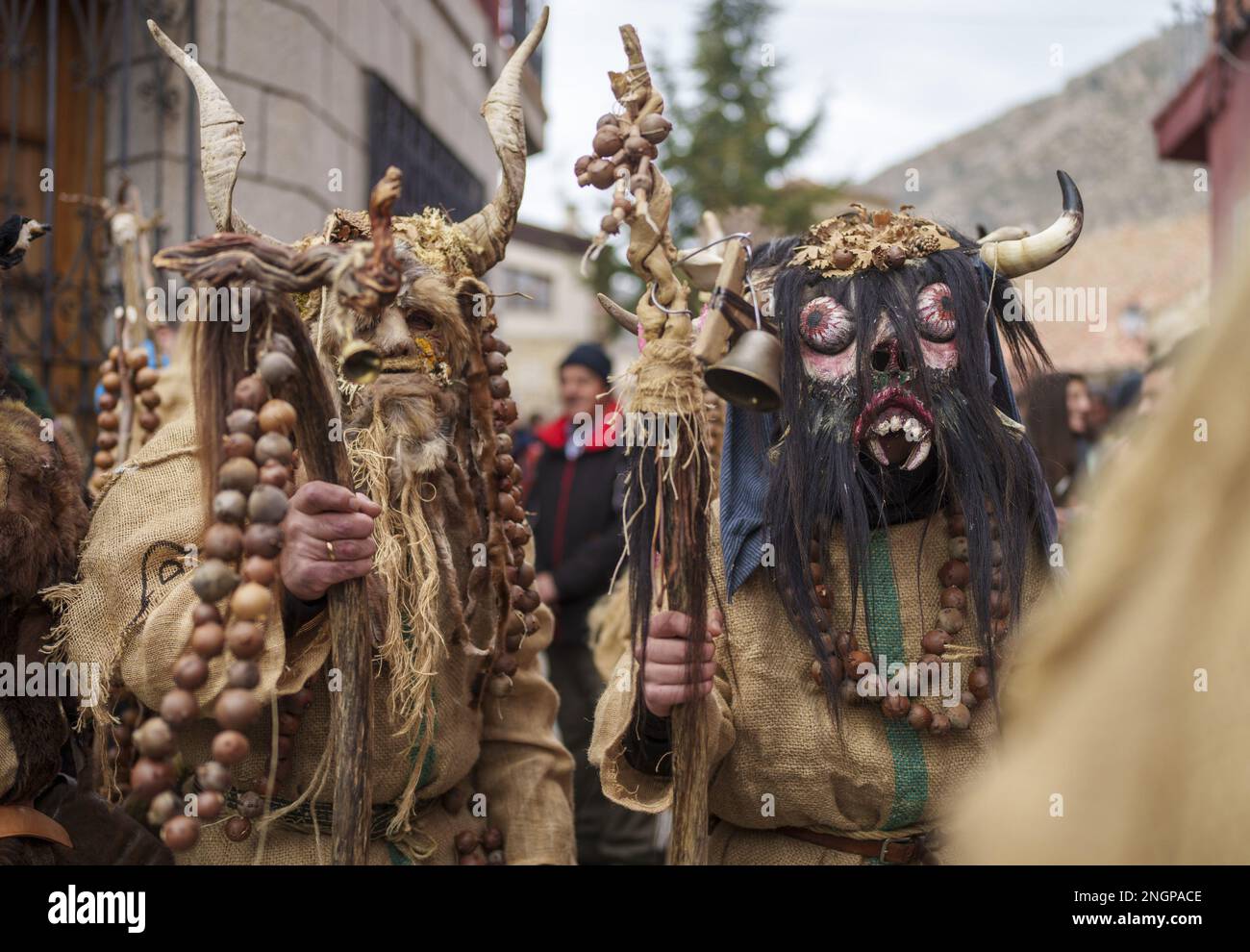 Navalacruz, Spain. 18th Feb, 2023. Carnival revellers dressed as a traditional 'Harramacho' wearing animal horns and other agricultural decor take part in a carnival festival in the village of Navalacruz, Spain, on Saturday, February 18, 2023. The 'Herramacho' figures, whose costumes are made from natural materials collected from the surrounding environment, were believed to protect family and cattle in pre-Roman rituals. Photo by Paul Hanna/UPI Credit: UPI/Alamy Live News Stock Photo
