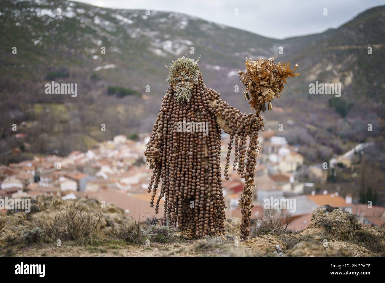 Navalacruz, Spain. 18th Feb, 2023. A carnival reveller dressed as a traditional 'Harramacho' wearing leaves and other agricultural decor takes part in a carnival festival in the village of Navalacruz, Spain, on Saturday, February 18, 2023. The 'Herramacho' figures, whose costumes are made from natural materials collected from the surrounding environment, were believed to protect family and cattle in pre-Roman rituals. Photo by Paul Hanna/UPI Credit: UPI/Alamy Live News Stock Photo