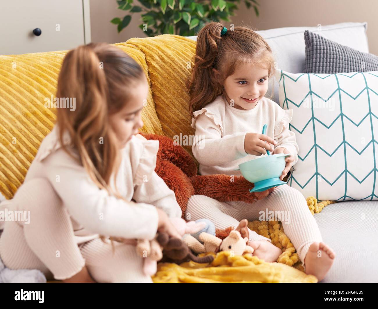Two girls playing with dolls hi-res stock photography and images - Alamy