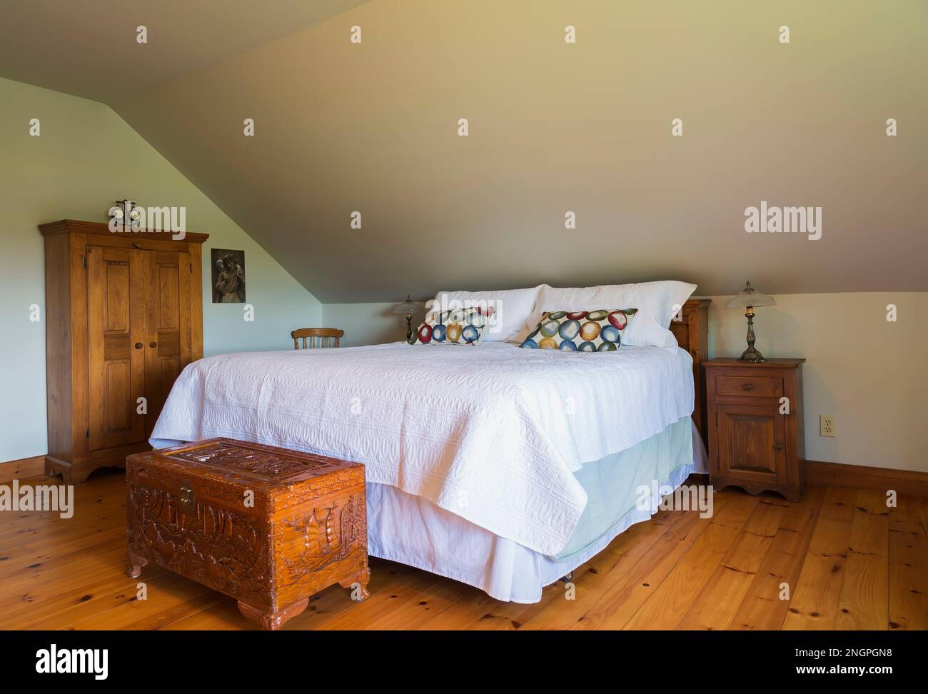 King size bed with carved exotic wooden chest and antique wooden