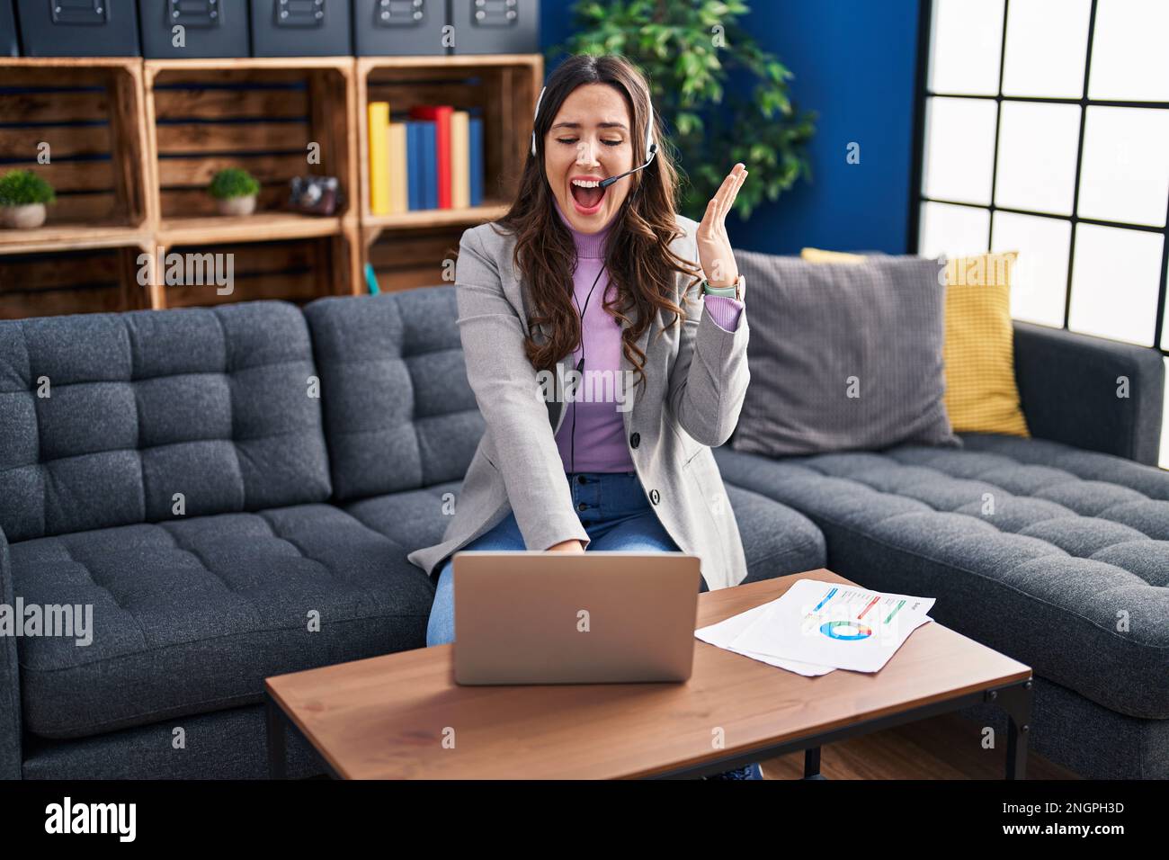 Young brunette woman working using computer laptop celebrating victory ...