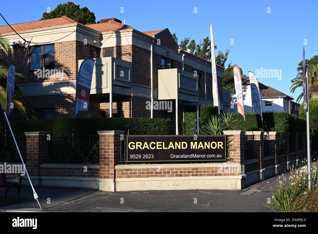 Exterior of Graceland Manor aged care facility, with various signs promoting that it is a multicultural institution Stock Photo