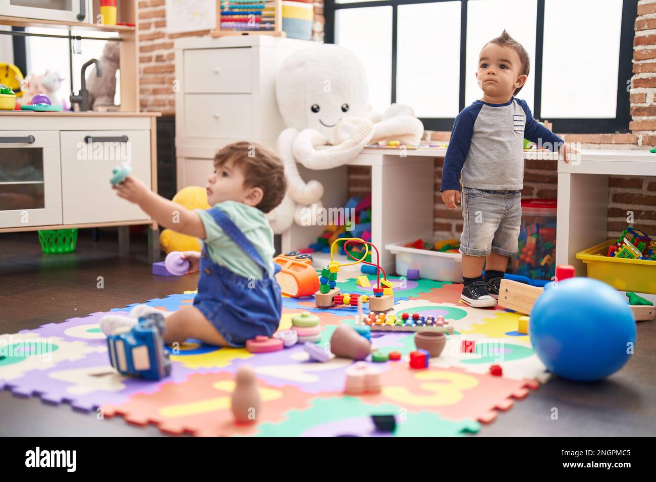 Two kids playing with toys at kindergarten Stock Photo - Alamy