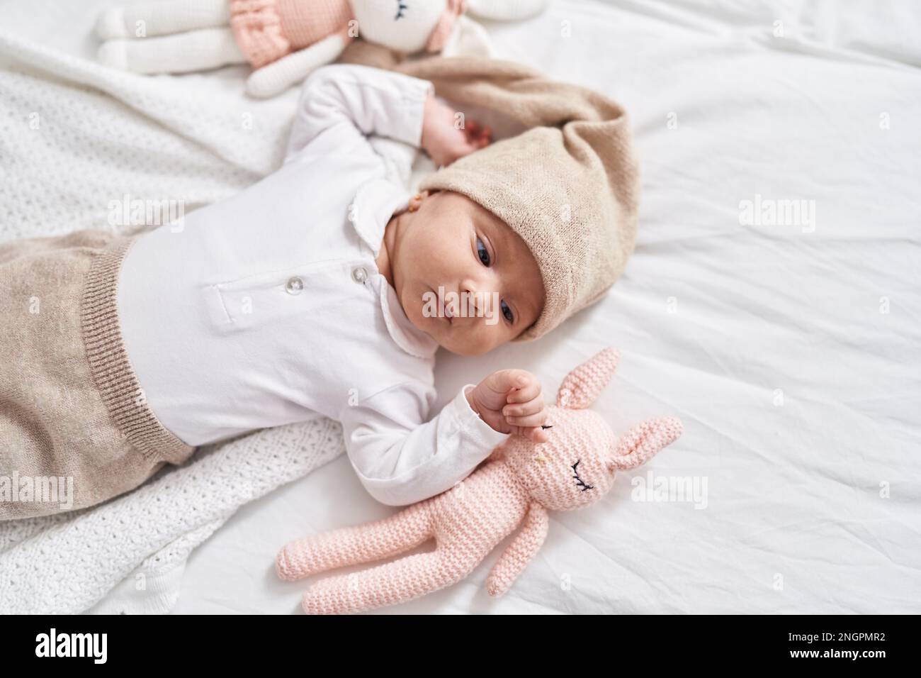 Adorable hispanic baby lying on bed at bedroom Stock Photo - Alamy
