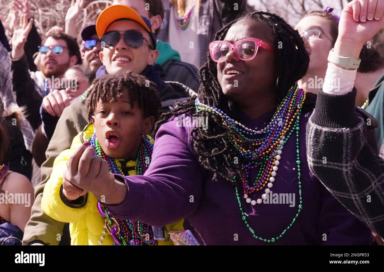 St. Louis, United States. 18th Feb, 2023. Parade goers work to catch