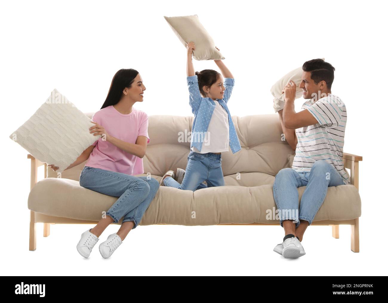 Happy family having pillow fight on comfortable sofa against white background Stock Photo