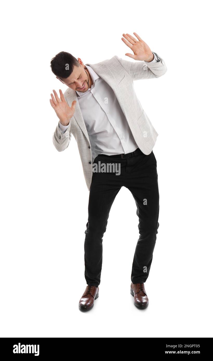 Emotional man evading something on white background Stock Photo - Alamy