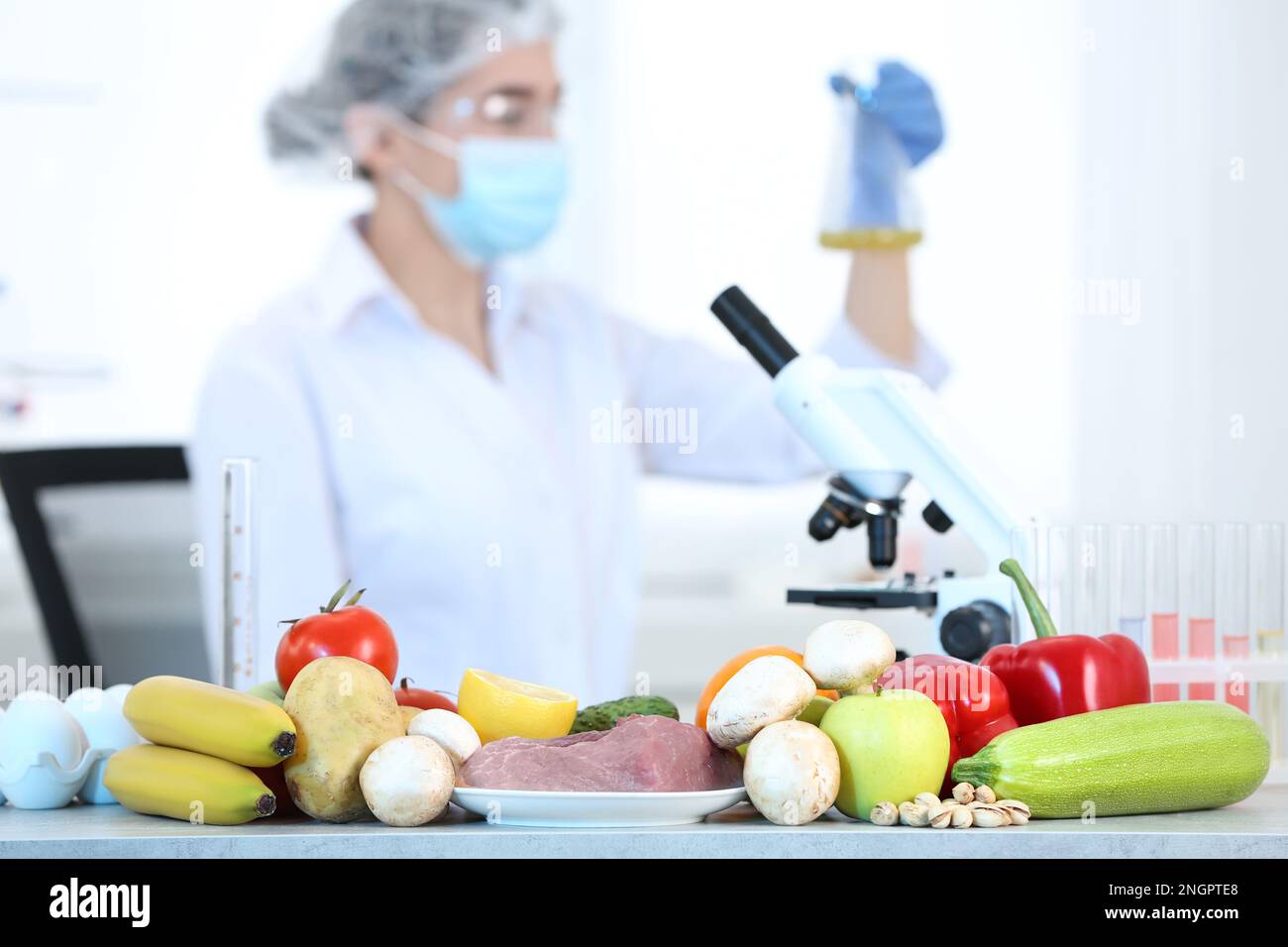 Fresh vegetables, fruits, meat on table and scientist proceeding