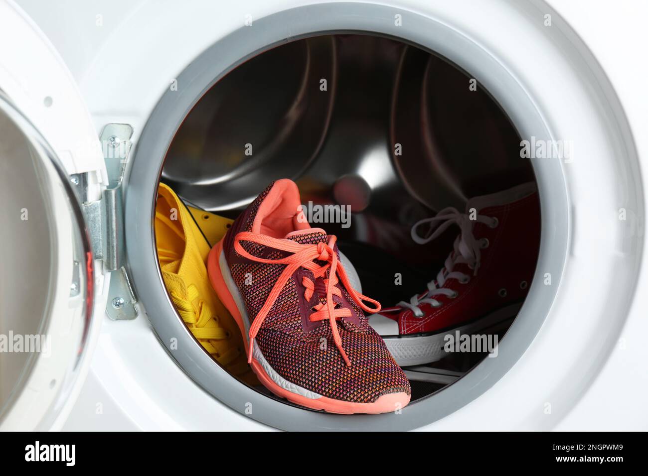 Clean sports shoes in washing machine drum Stock Photo Alamy