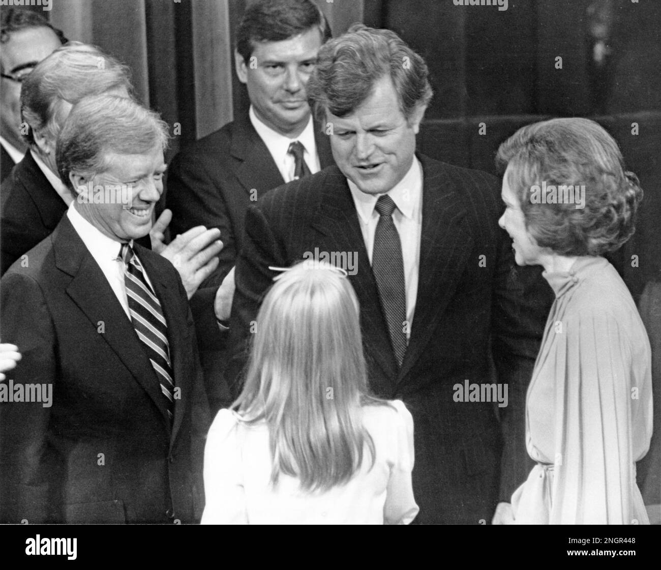 New York, NY - (FILE) -- United States President Jimmy Carter, left, U.S. Senator Edward M. 'Ted' Kennedy (Democrat of Massachusetts), center, first lady Roslyn Carter, right, and Amy Carter, back to camera, on the podium on the last night of the 1980 Democratic National Convention in New York, New York on Thursday, August 14, 1980 in a show of unity after a bruising battle for the party's nomination for President.Credit: Arnie Sachs/CNP Stock Photo
