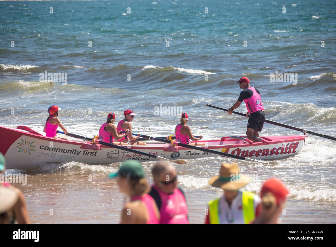 Traditional surfboat racing on Collaroy beach in Sydney, summer 2023, NSW,Australia, Queenscliff womens team with male sweep Stock Photo
