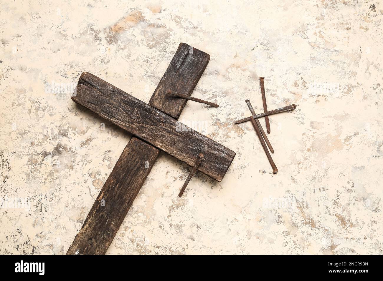 Wooden cross with nails on grunge background. Good Friday concept Stock