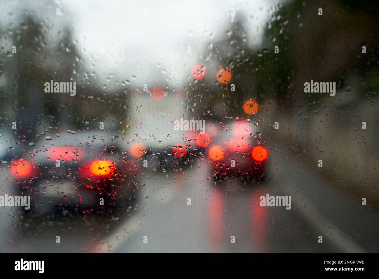 Traffic stand still on a cold wet day, shot through a windshield
