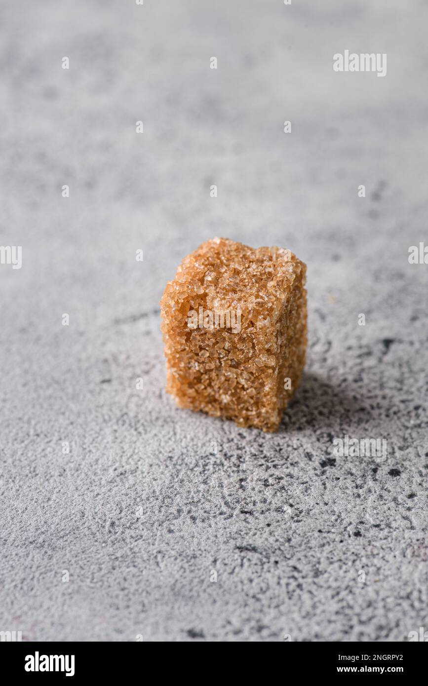 brown sugar cubes on a gray background. Macro Stock Photo