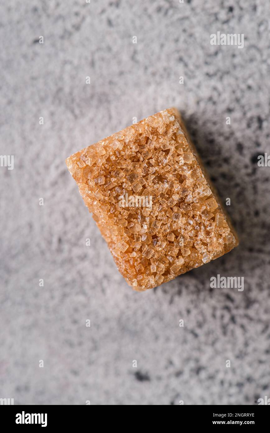 brown sugar cubes on a gray background. Macro Stock Photo