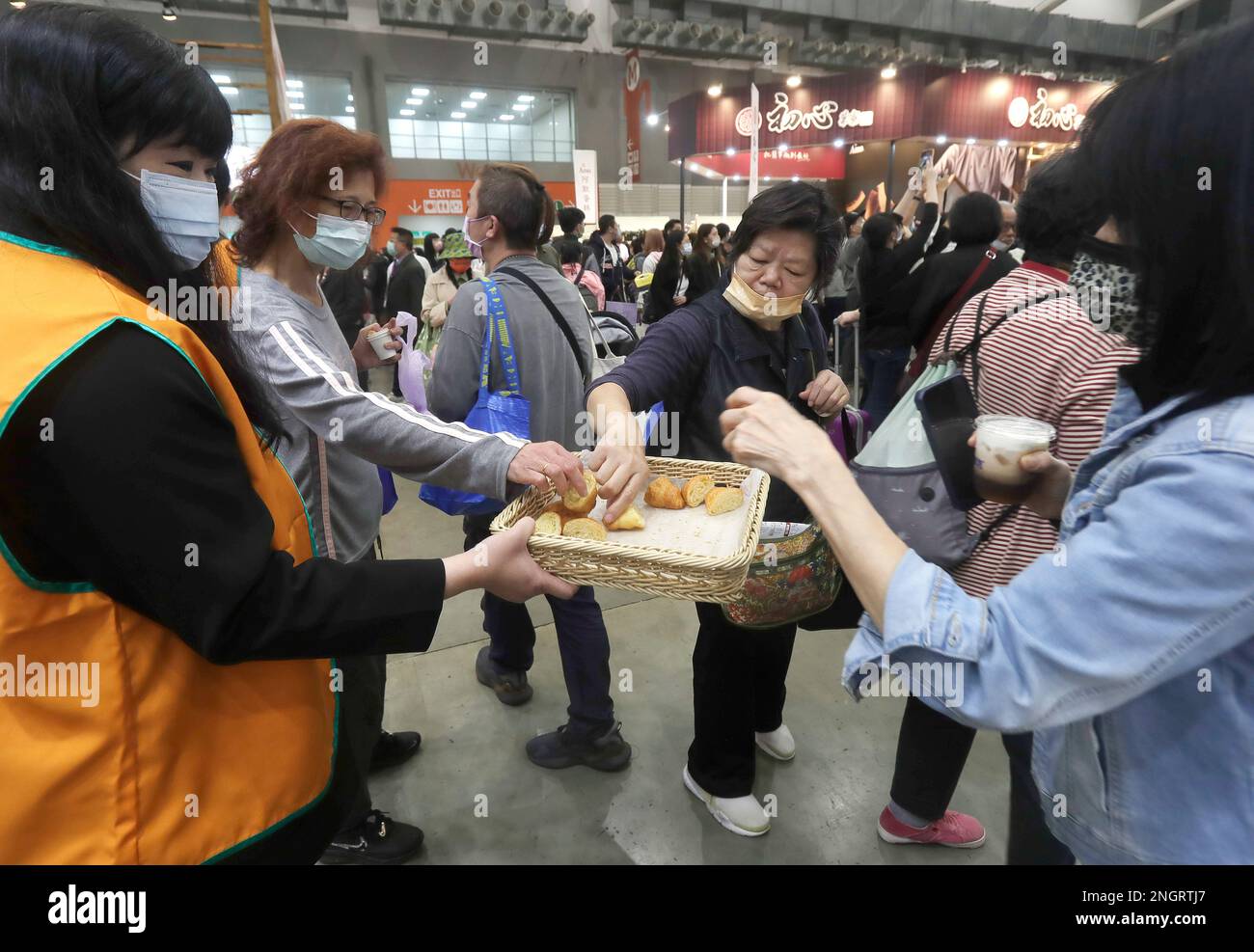 People taste freshly baked bread during the Bakery Show at Taipei