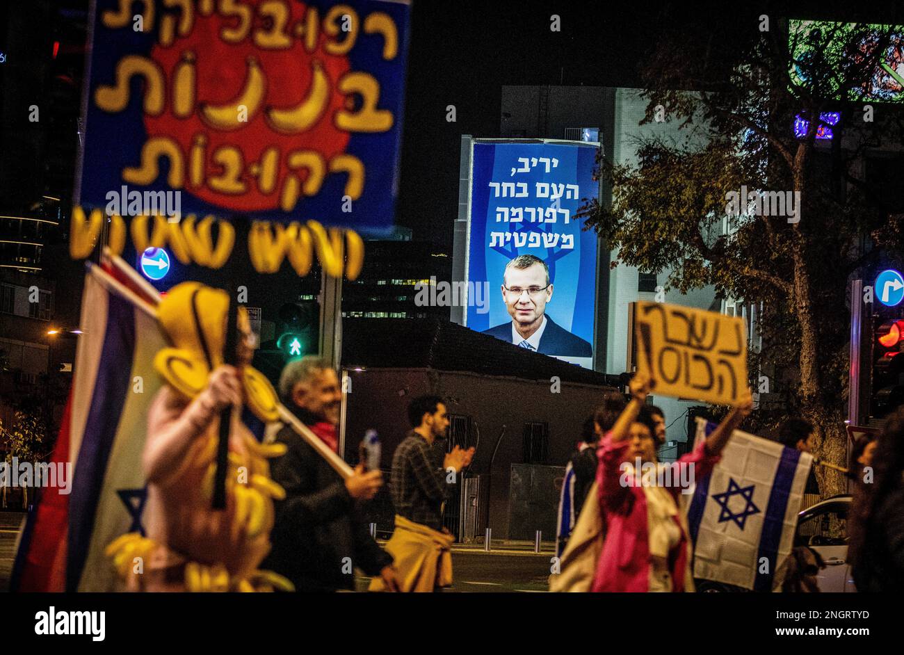 Tel Aviv, Israel. 18th Feb, 2023. Protesters with placards walk past a portrait of the Minister of Justice Yariv Levin, during the demonstration. People protested in Tel Aviv against Prime Minister Benjamin Netanyahu's right-wing government and its controversial legal reform. The proposed legal reform would allow the parliament to overrule the Supreme Court's decision with a majority voting among the 120-seat lawmakers. However, they appoint judges, which boost their political influence over the system. Credit: SOPA Images Limited/Alamy Live News Stock Photo