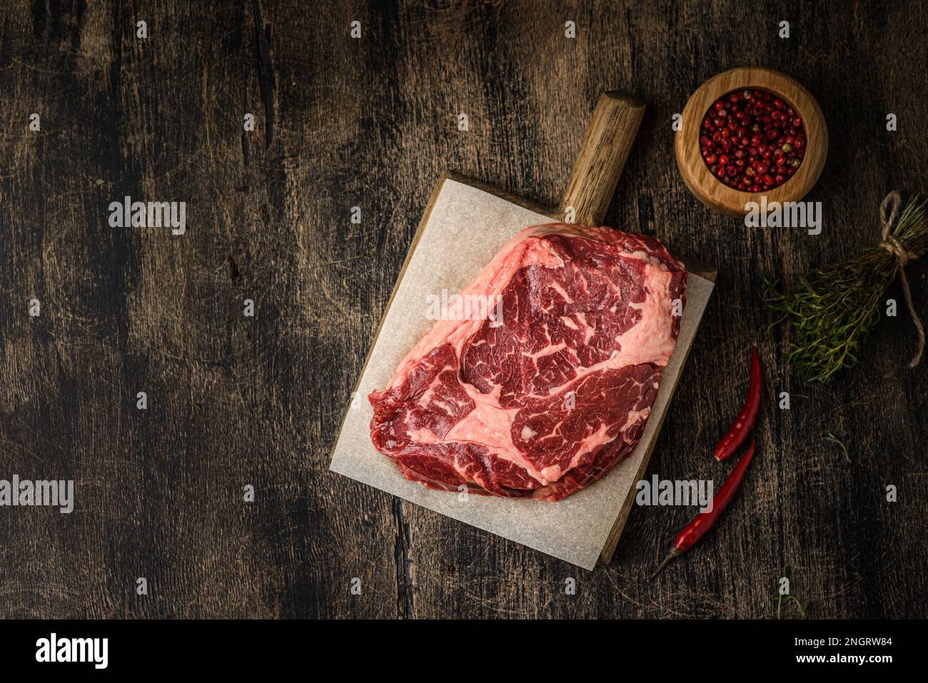 raw rib eye steak on a wooden background. High quality photo Stock Photo