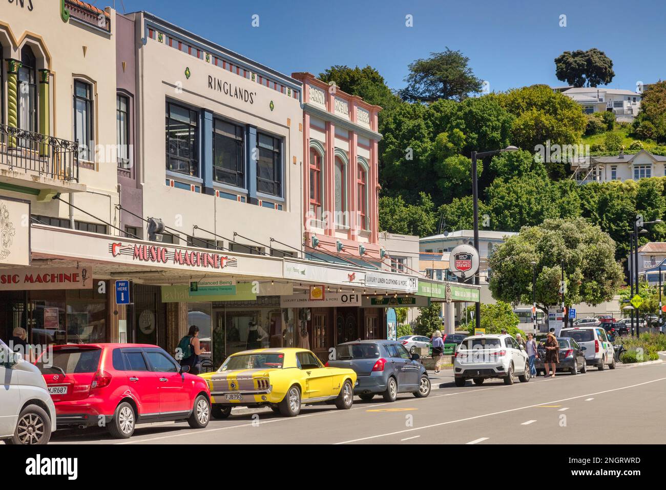 5 December 2022: Napier, Hawkes Bay, New Zealand - Art deco buildings in Hastings Street, Napier, with shops at street level. Cars parked outside shop Stock Photo