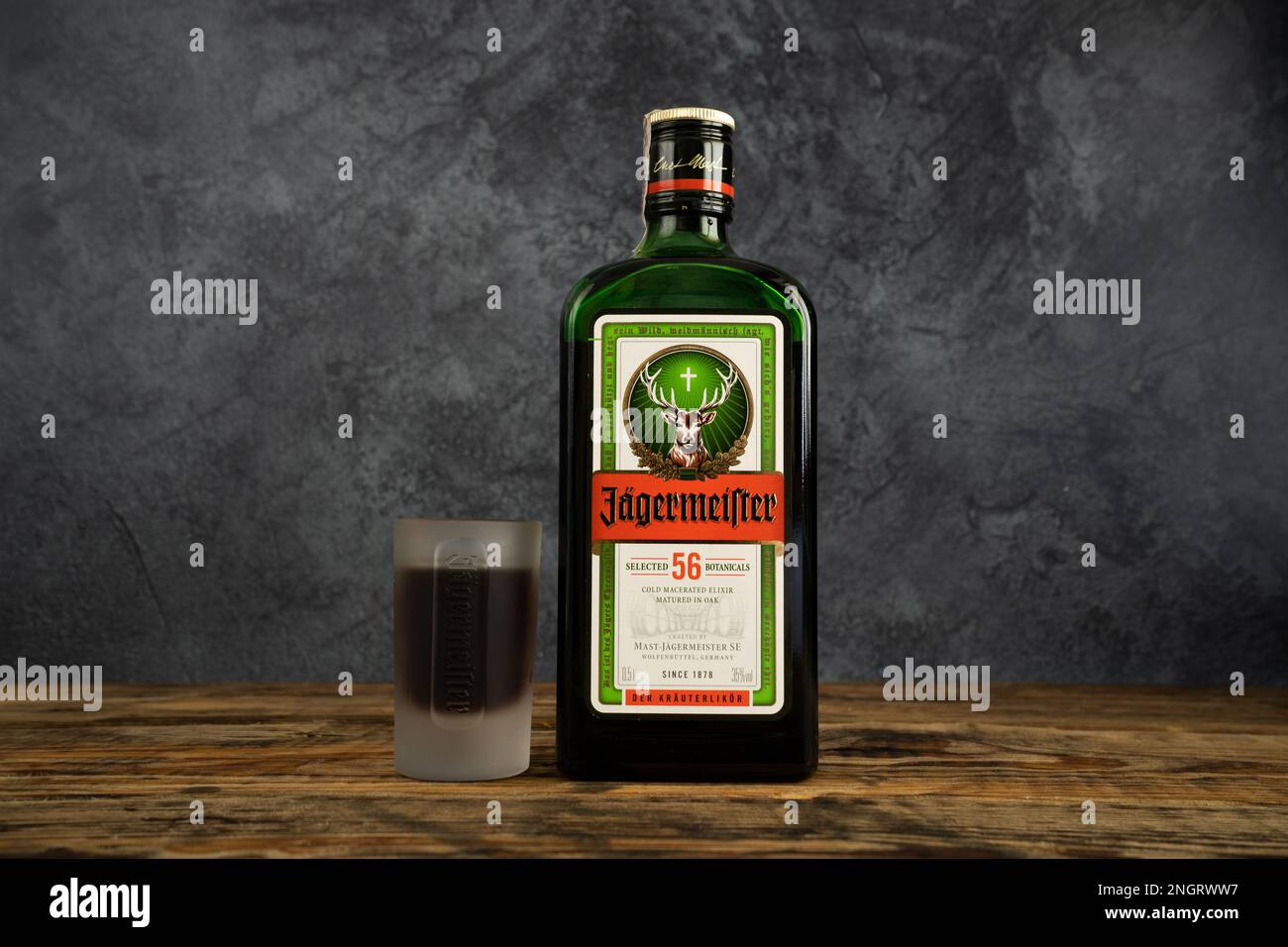 Jägermeister bottle and shot glass. German digestive alcohol drink (digestif). Jagermeister liqueur made with 56 herbs and spices. Stock Photo