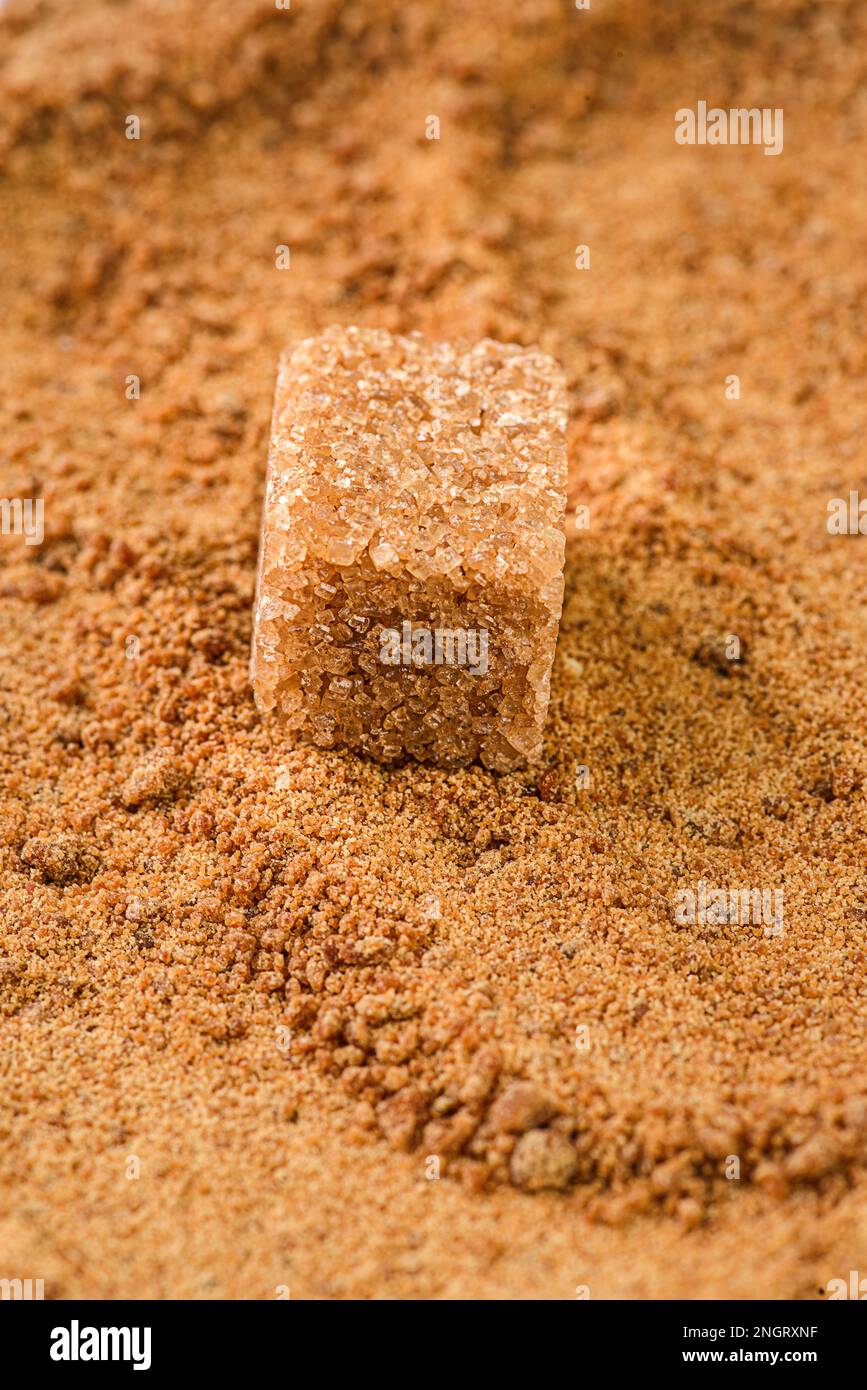 a cube of brown sugar on granulated sugar Stock Photo