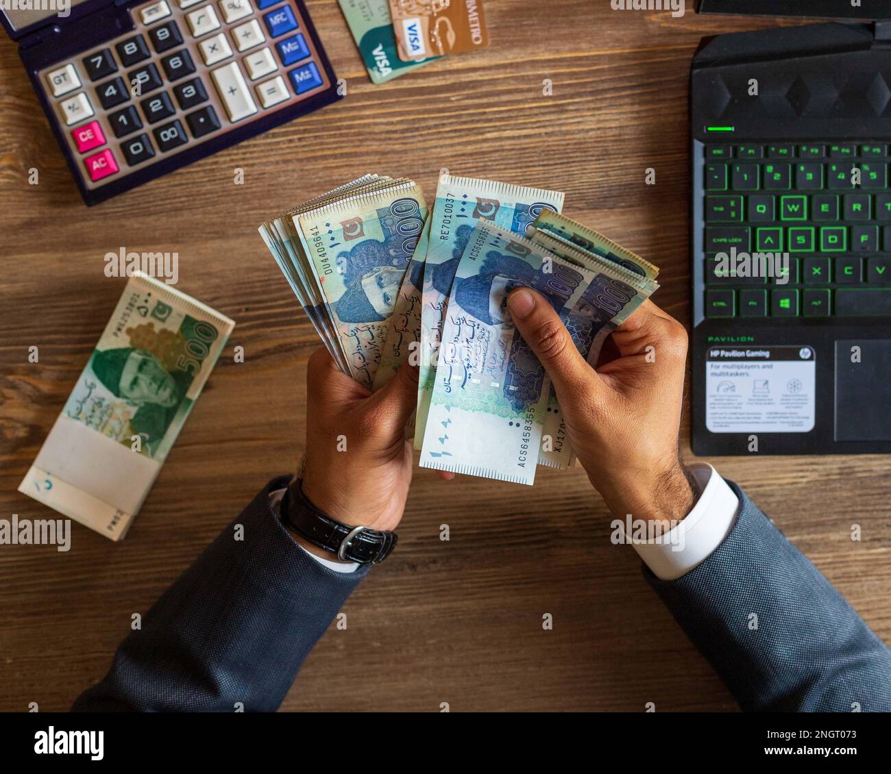 Business man hand counting Pakistani currency notes for budget Saving money investment and financial accounting management or growing business concept Stock Photo
