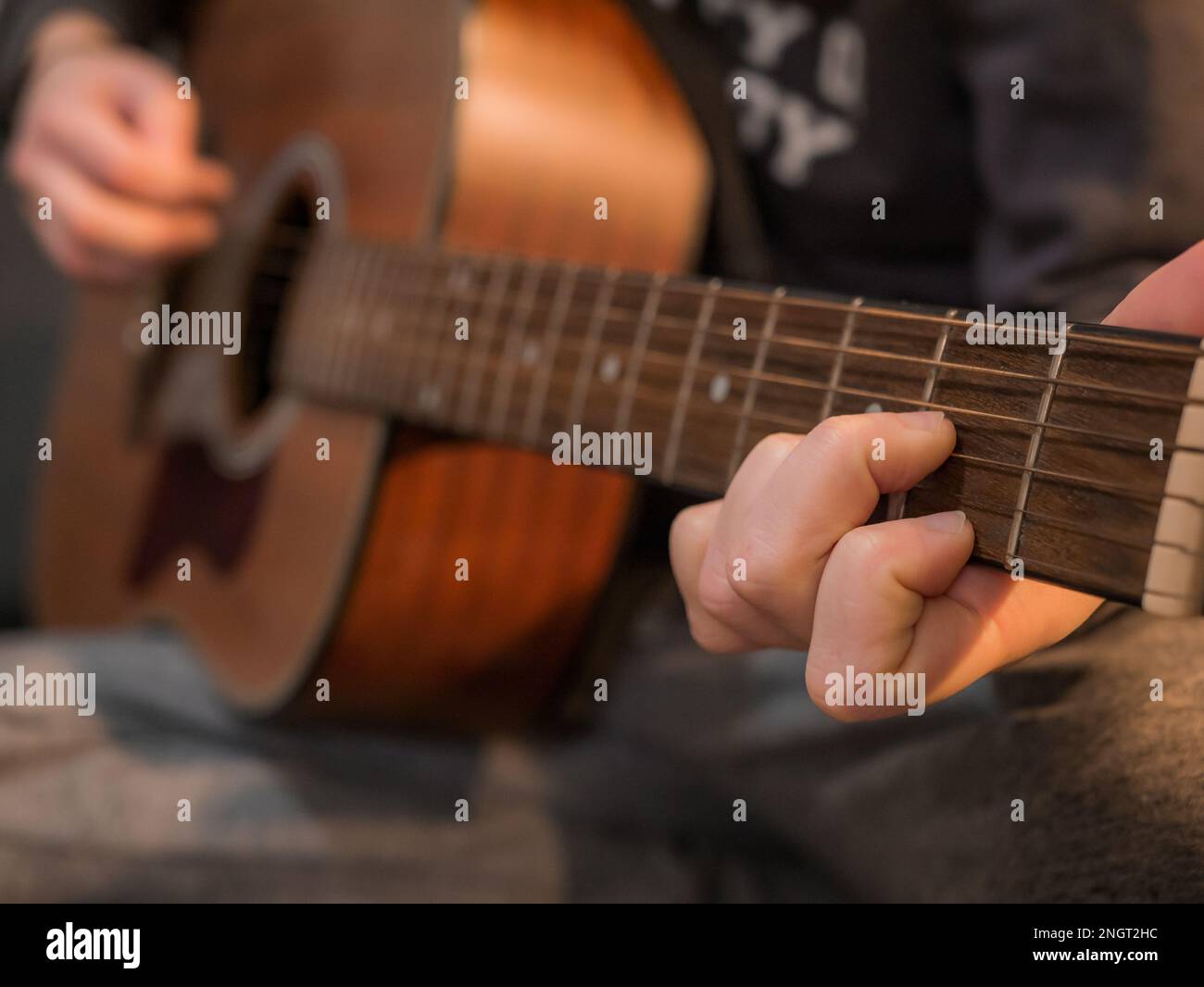 Practice playing the acoustic guitar. Hands playing guitar and picking