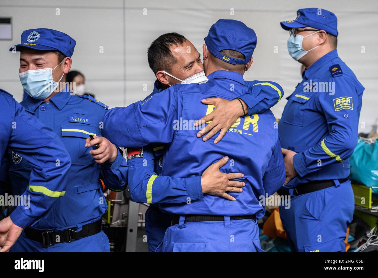 GUANGZHOU, CHINA - FEBRUARY 19, 2023 - Rescue workers embrace each other at Baiyun Airport in Guangzhou, Guangdong province, China, February 19, 2023. Stock Photo