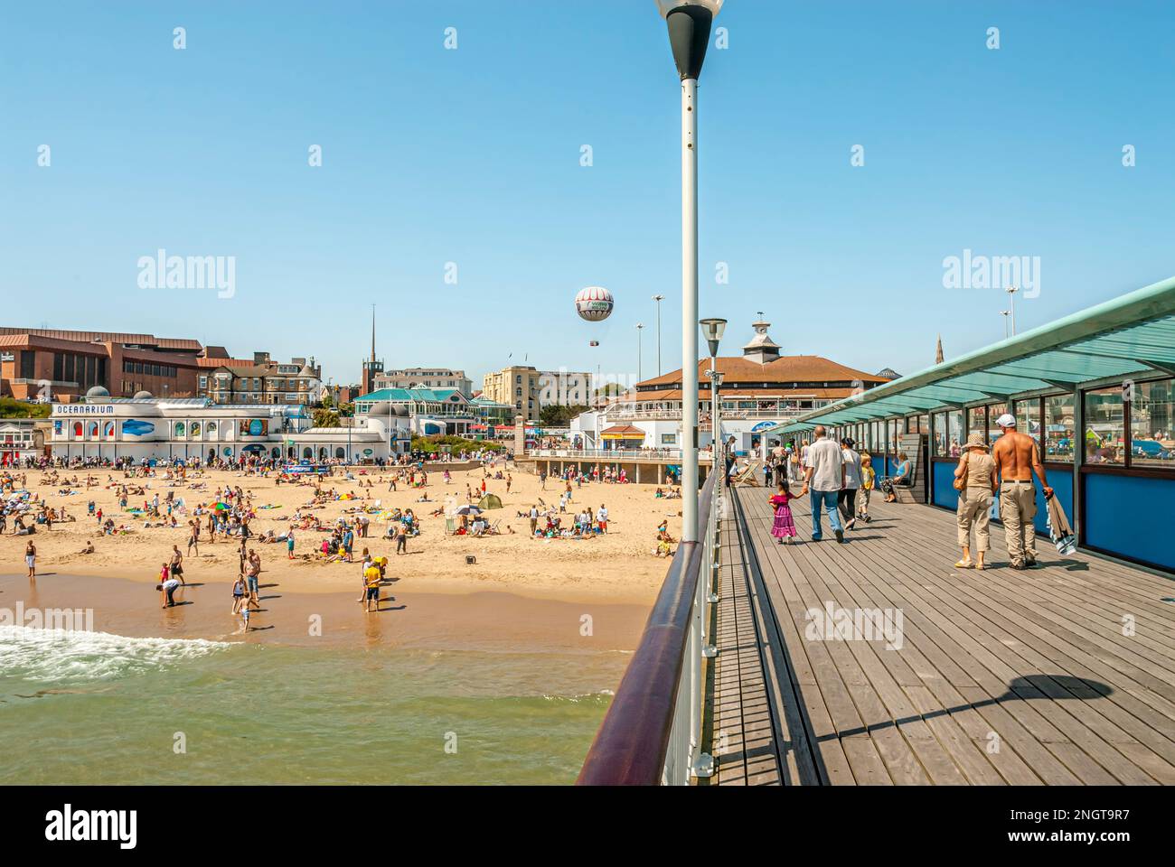 Tourists at the beach and pier of Bournemouth in Dorset, South England Stock Photo