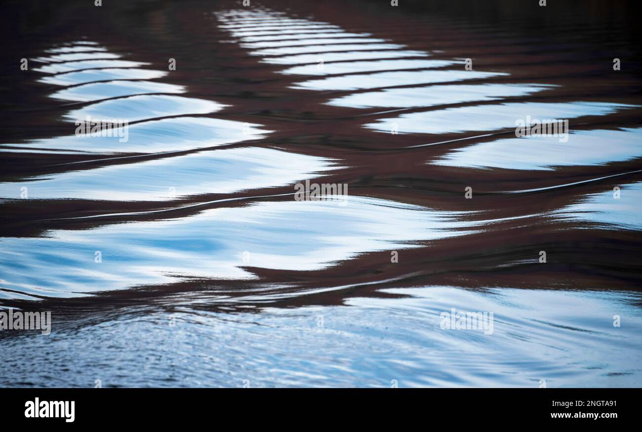 Unusual abstract landscape image of wake and ripples caused by boat on ...