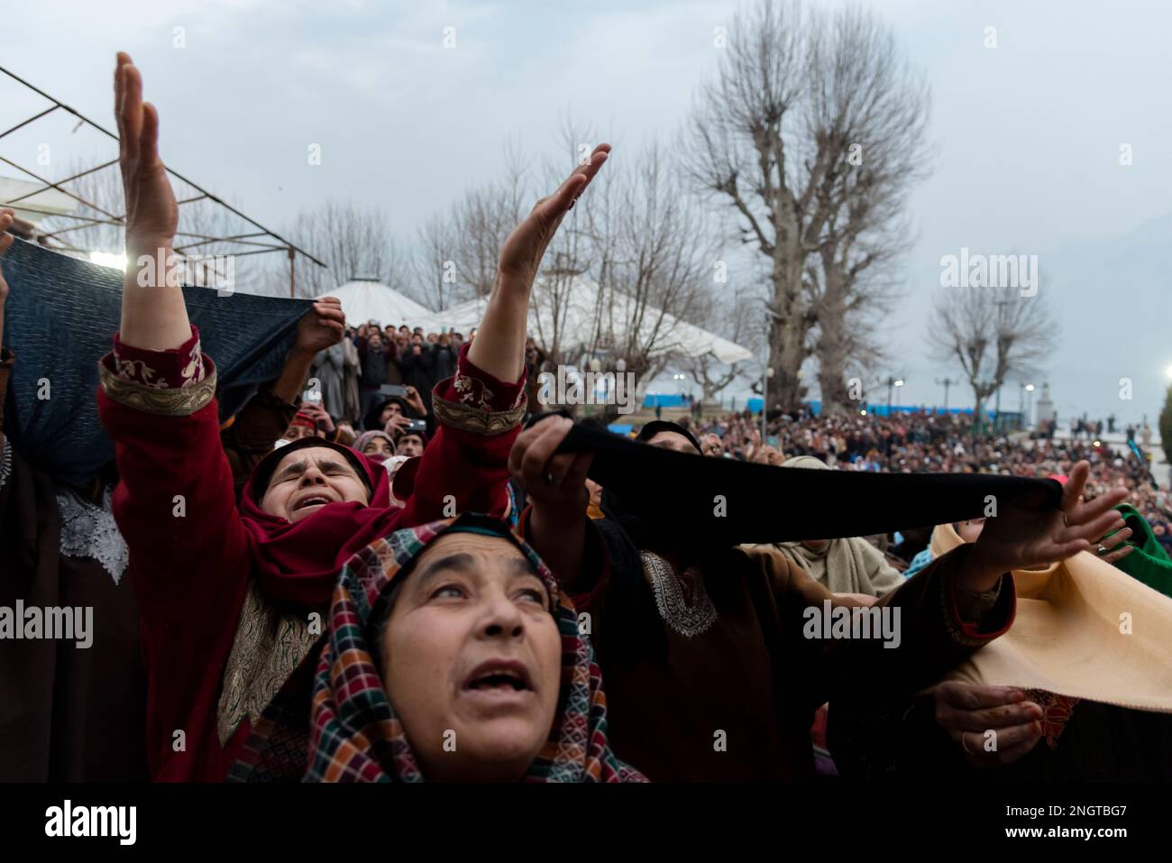 Muslim devotees cry while praying upon seeing the holy relic on the