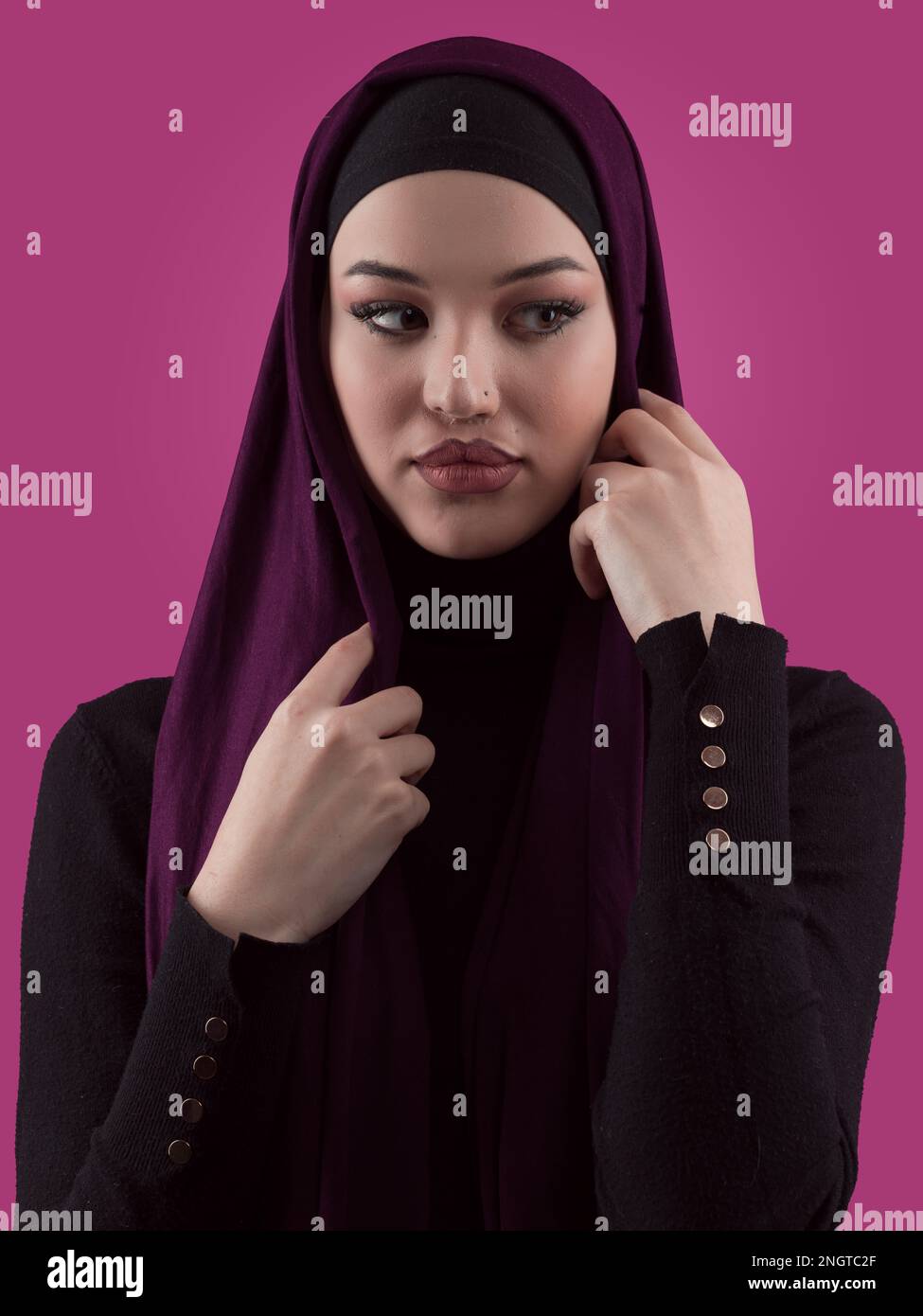 Modern Muslim woman wearing stylish hijab casual wear isolated on pink ...