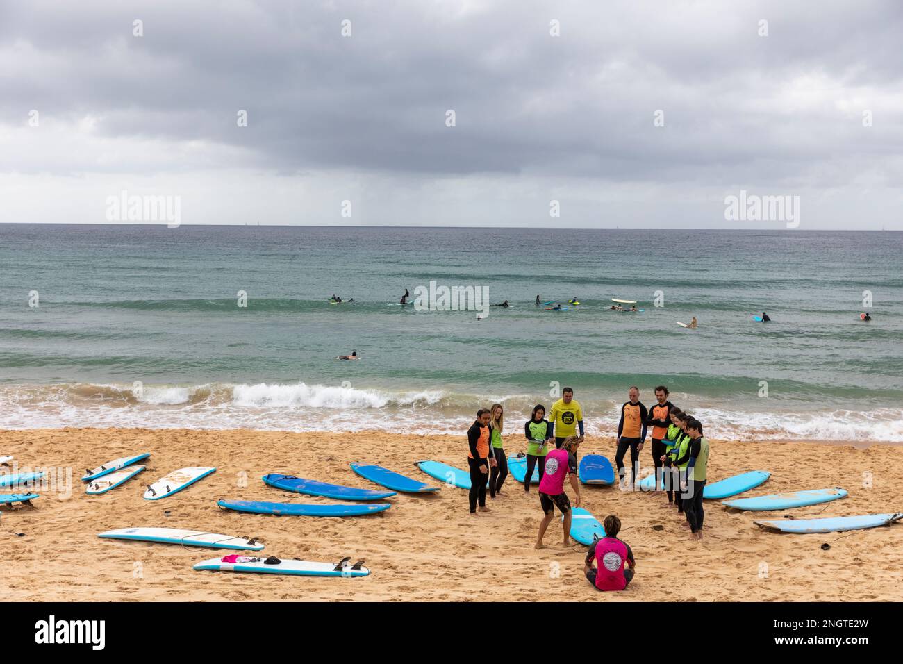 Group of people having surfboard surfing lessons on Manly Beach in