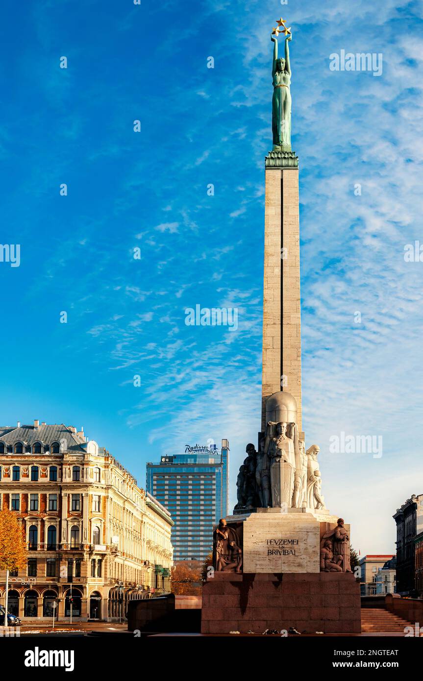 RIGA, LATVIA - 0CTOBER 28, 2012: Riga's monument of freedom dominates the city skyline. Stock Photo