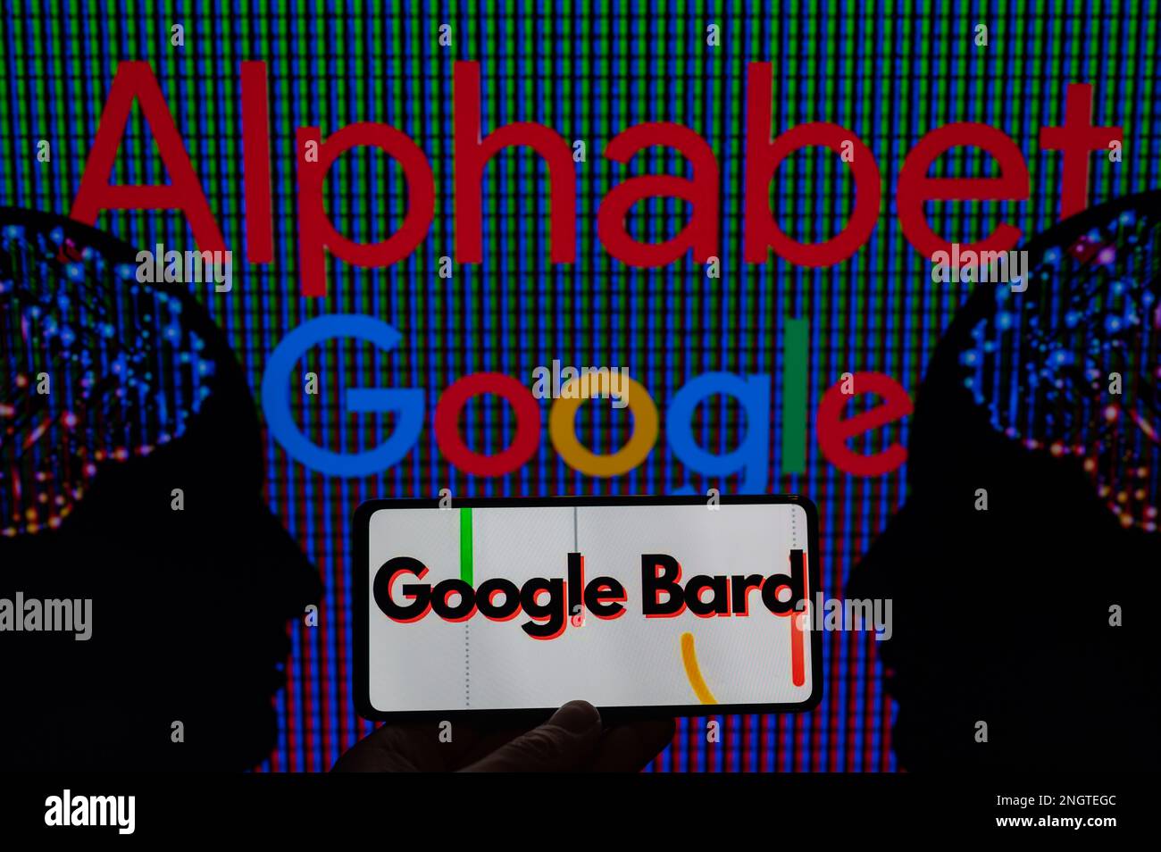 Google Alphabet displayed on screen with Google Bard on mobile seen in