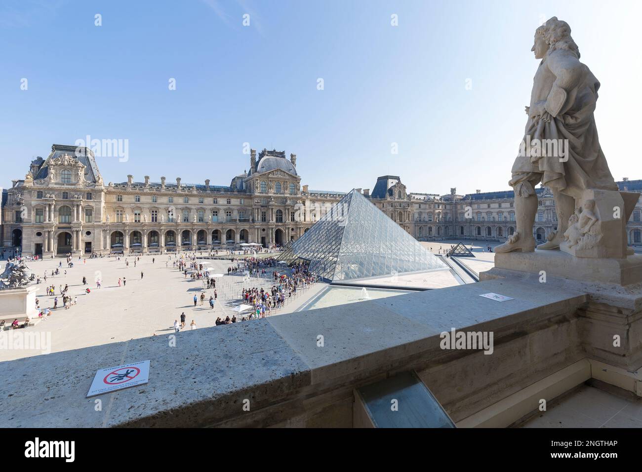 Paris, France - 2022, August 31: the Louvre museum courtyard in a sunny summer day. Stock Photo