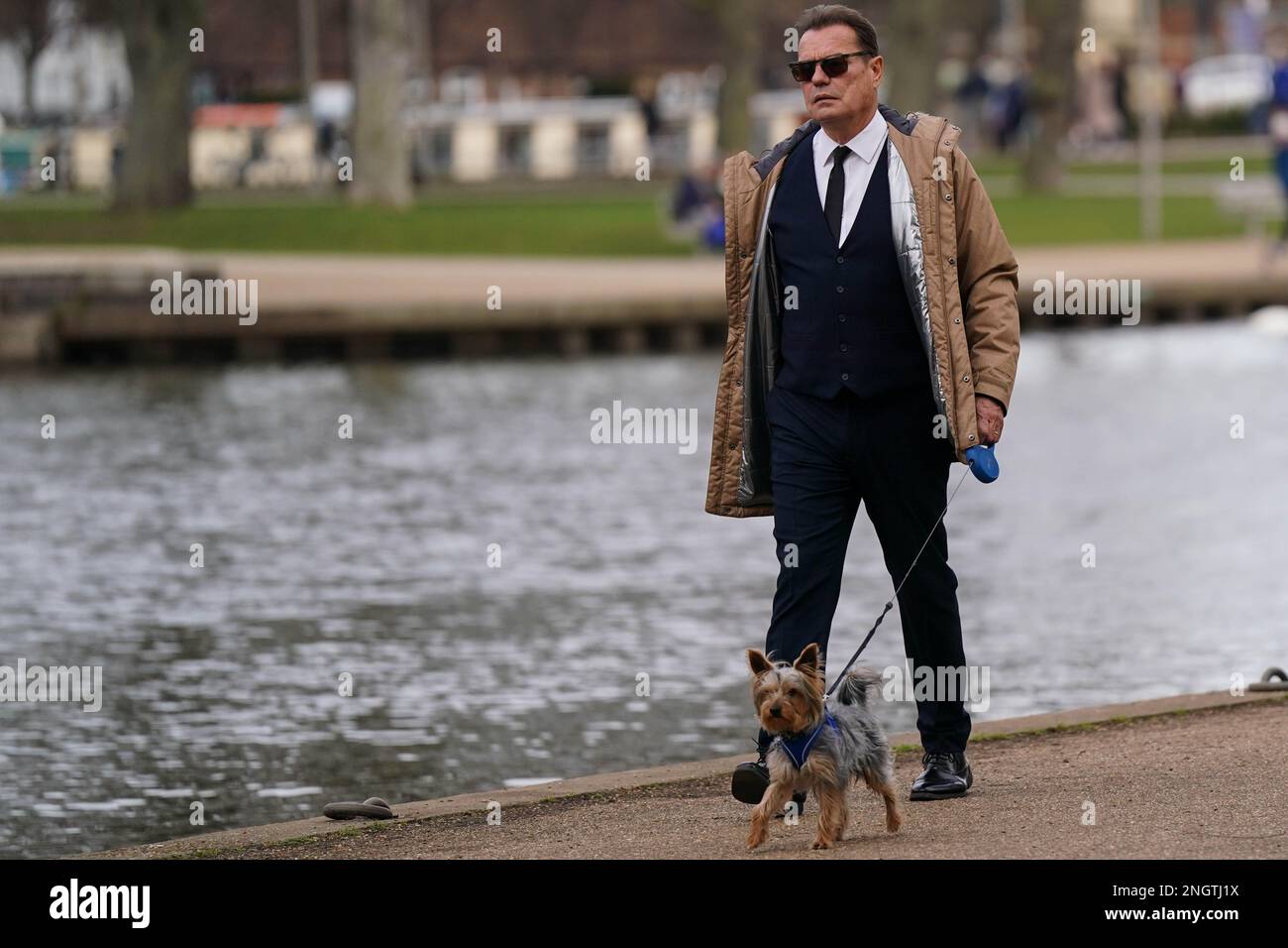 A man walks his dog by the river in StratforduponAvon in Warwickshire