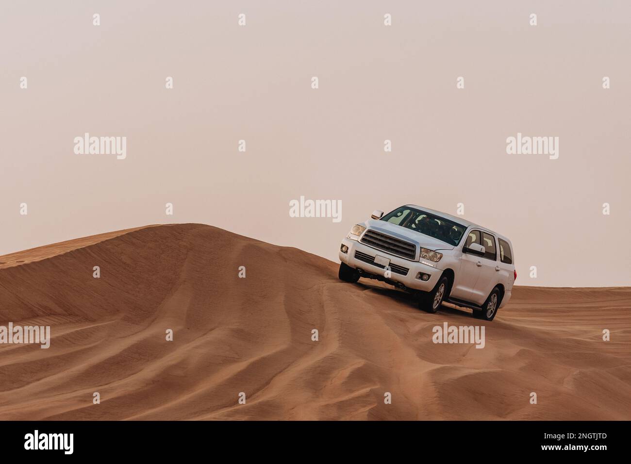 Dubai, United Arab Emirates - 01, July 2021 : The car ride at Arabian Desert over the dunes. A warm day in the desert. Stock Photo