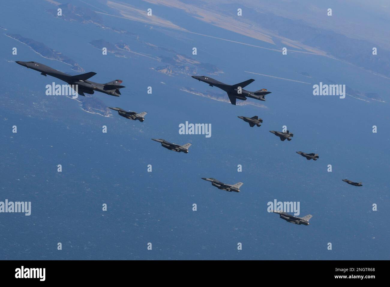 Seoul, South Korea. 19th Feb, 2023. (In this handout photos released by South Korean Defense Ministry), U.S. Air Force B-1B bomber, (top), flies in formation with U.S. Air Force F-16 fighter jets over the South Korea Peninsula during a joint air drill in South Korea on February 19, 2023. (Photo by: Korean Defense Ministry via Credit: Sipa USA/Alamy Live News Stock Photo