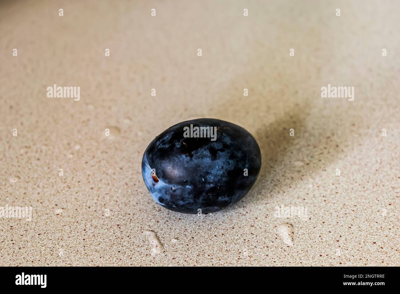 The plum on the wooden table Stock Photo