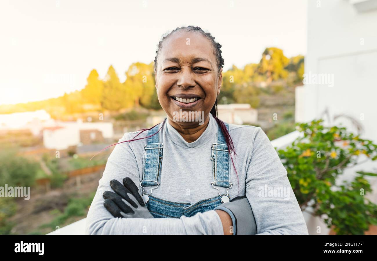 Happy African woman gardening at home Stock Photo
