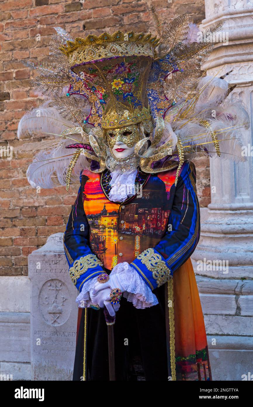 Carnival goer dressed in splendid costume and mask during Venice ...