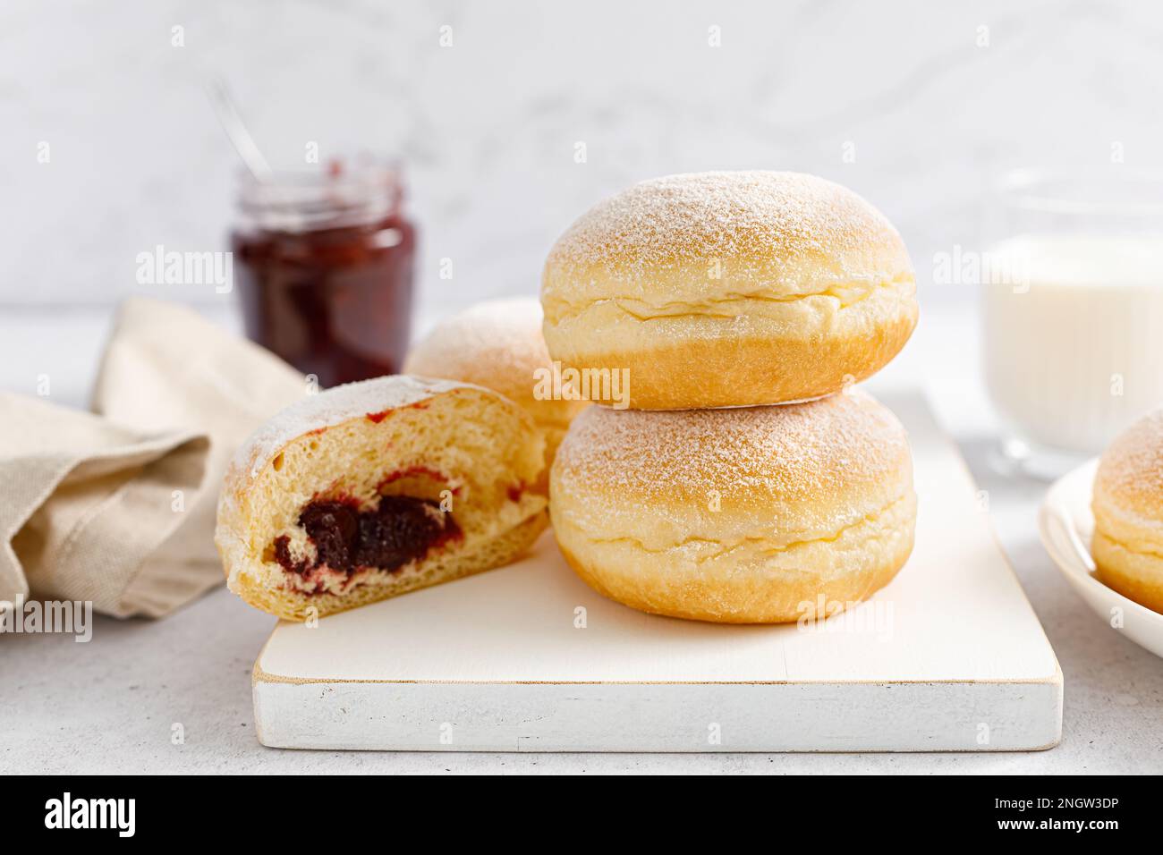 Berliner donut. Traditional german donut with raspberry jam, dusted with icing sugar Stock Photo