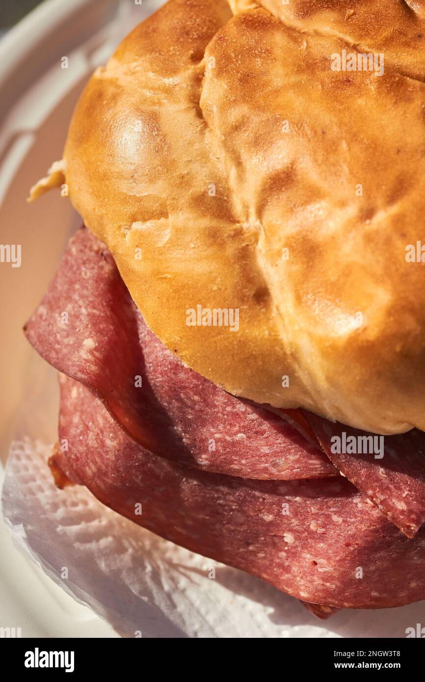 Lebanon bologna sandwich made with a pretzel roll. A Pennsylvania Dutch