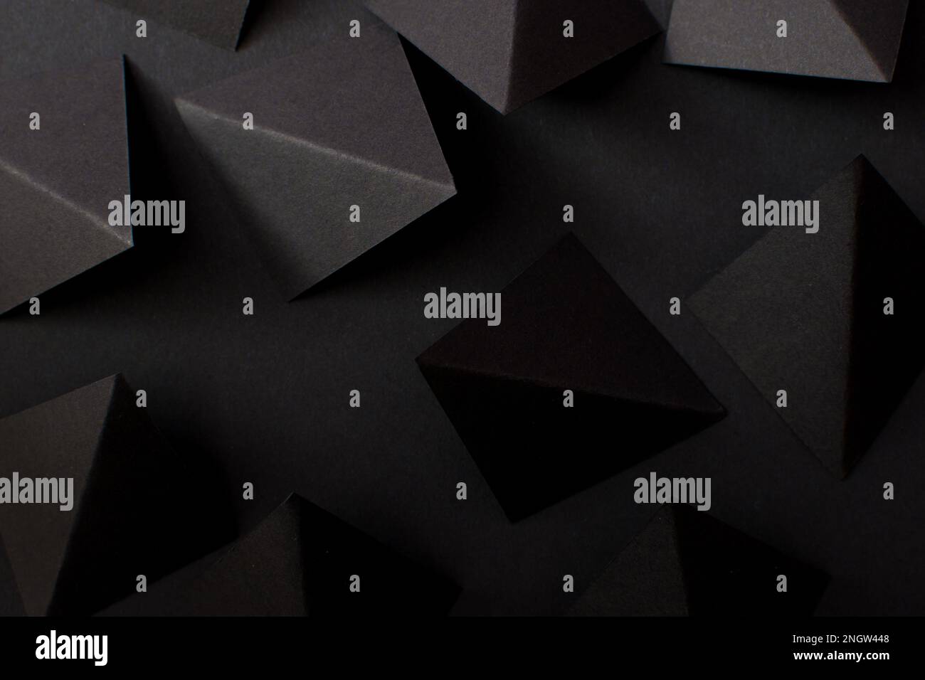 Black paper folded in geometric shapes Stock Photo Alamy
